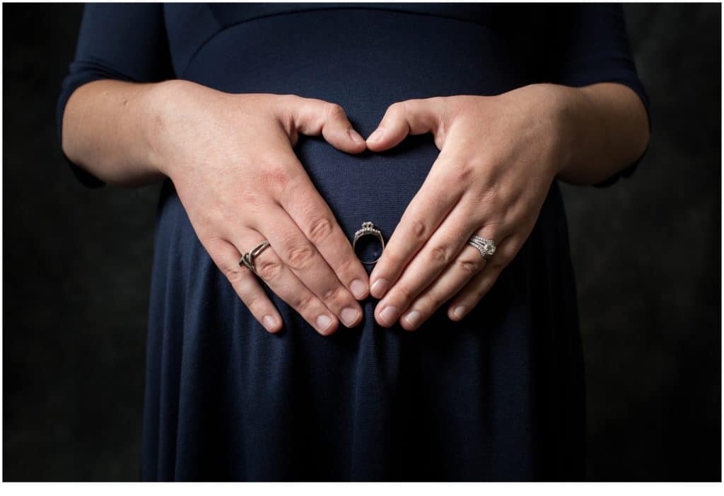 Hands in a heart shape on belly - Maine Maternity Portraits