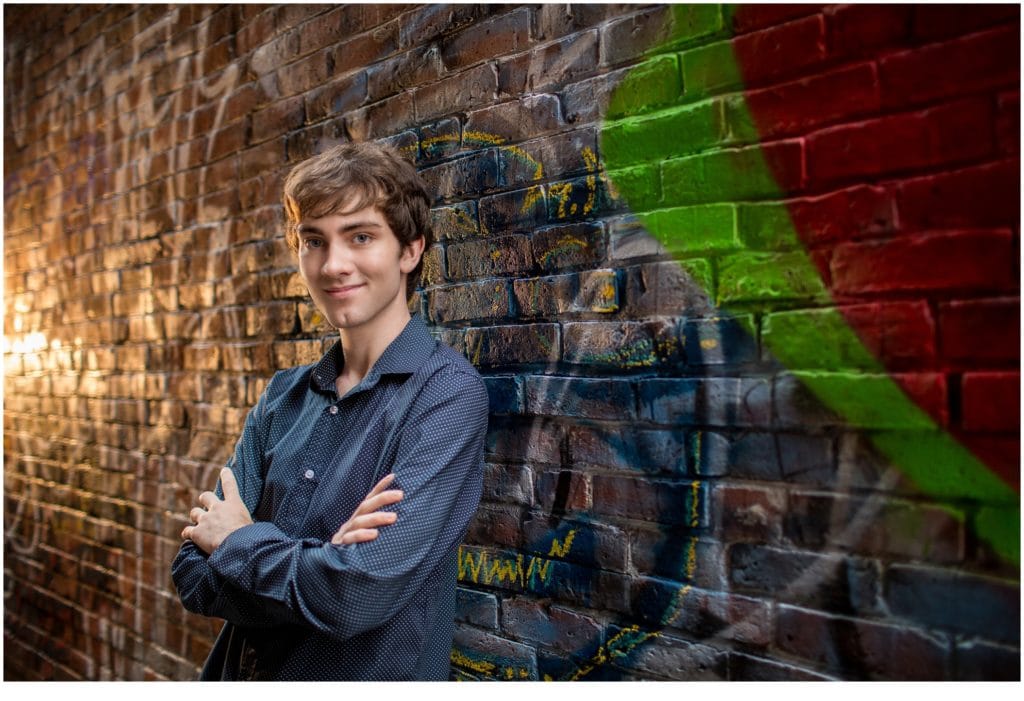 2021 Hall-Dale Senior, Nick, Leaning against brick wall with Graffiti on it